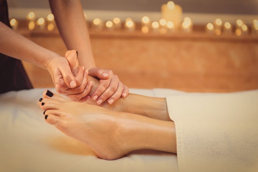Woman getting her feet massaged.
