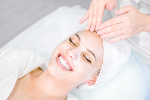girl smiling getting a facial