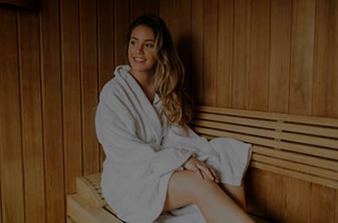 Pod image of girl sitting inside an infrared sauna.